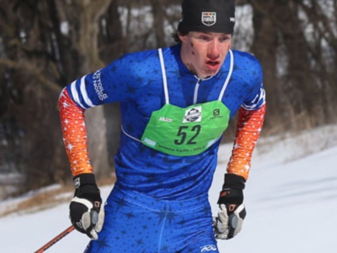 Freestyle nordic skier wearing a green 360 Race Bib number 52 on course