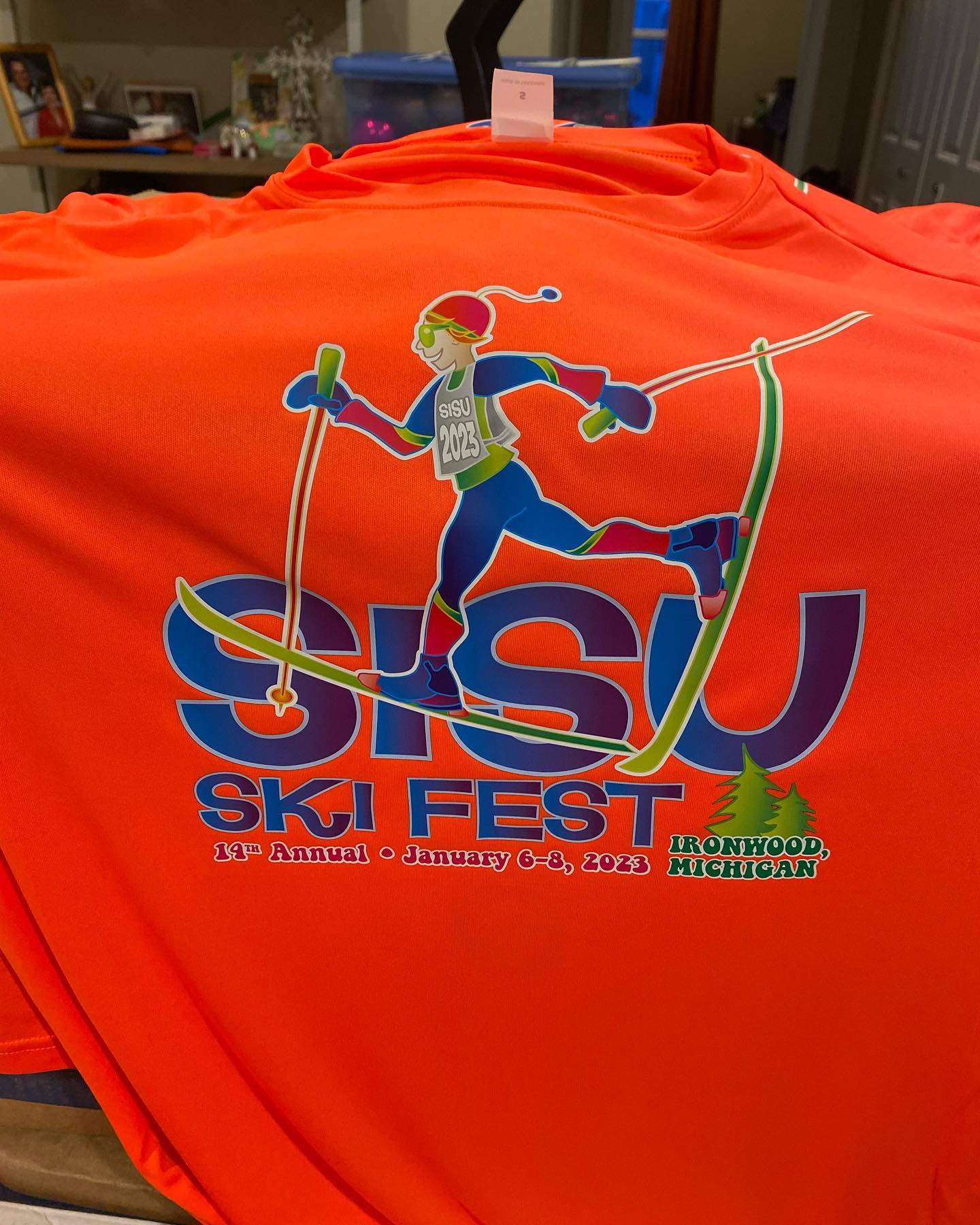 SISU Ski Fest event tee in safety orange with the full-color race logo